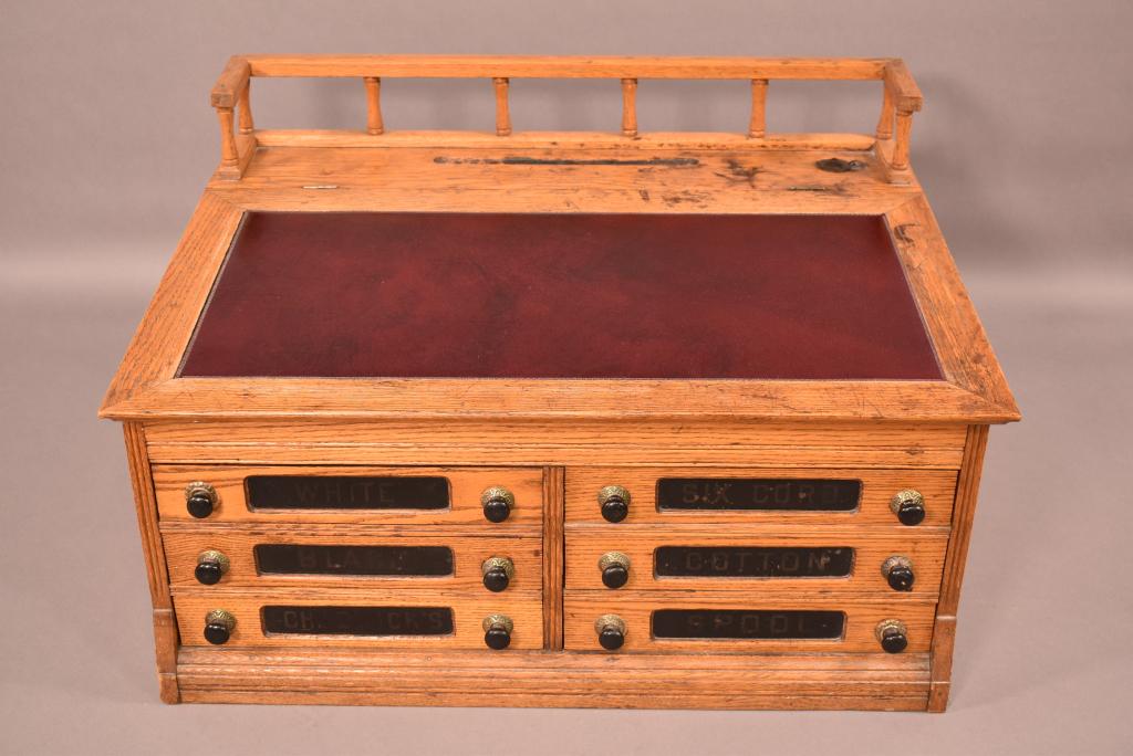 ANTIQUE OAK TABLE TOP GENERAL STORE SPOOL CABINET: 33" X 24" X 20"--NICE SPOOL CABINET DESK--STAINS TO TOP--HAS ORIGINAL INKWELL--6 DRAWERS--PANELED SIDES