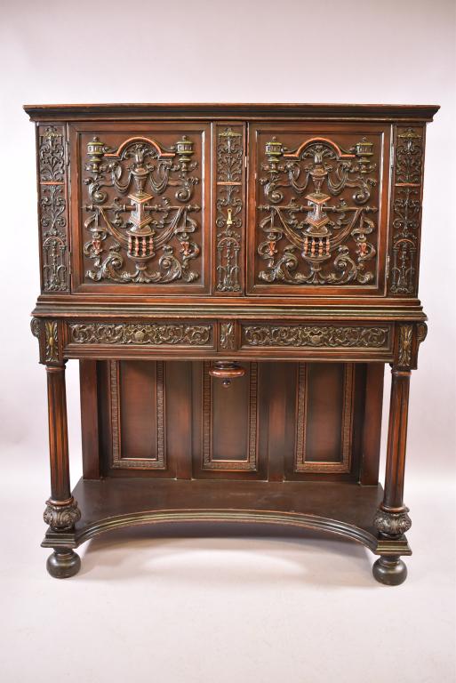 1930s CARVED SPANISH STYLE 2 DOOR CABINET: HIGHLY CARVED FRONT FRONT -- MINOR PAINT LOSS -- FINISH IS WORN & MINOR VENEER DAMAGE TO TOP -- 45" x 19" x 55 1/4"