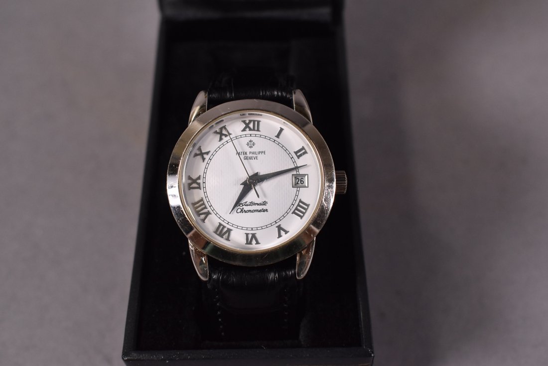 REPLICA PATEK PHILIPPE GENTLEMAN'S WATCH: AUTOMATIC CHRONOMETER WITH NEW LEATHER BAND--APPEARS TO WORK BUT ALL WATCHES SOLD ASIS--WATCH HAS SOME WEAR