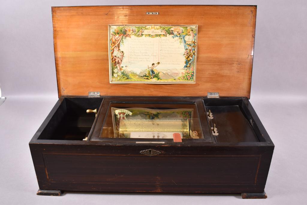 ANTIQUE SWISS CYLINDER MUSIC BOX: 20 SONG CYLINDER, SINGLE COMB, NO BROKEN TEETH IN COMB, FLORAL PAINTED TOP (SOME DAMAGE), WORKING CONDITION, SOME INLAY MISSING TO FRONT, 24" x 11" x 8"