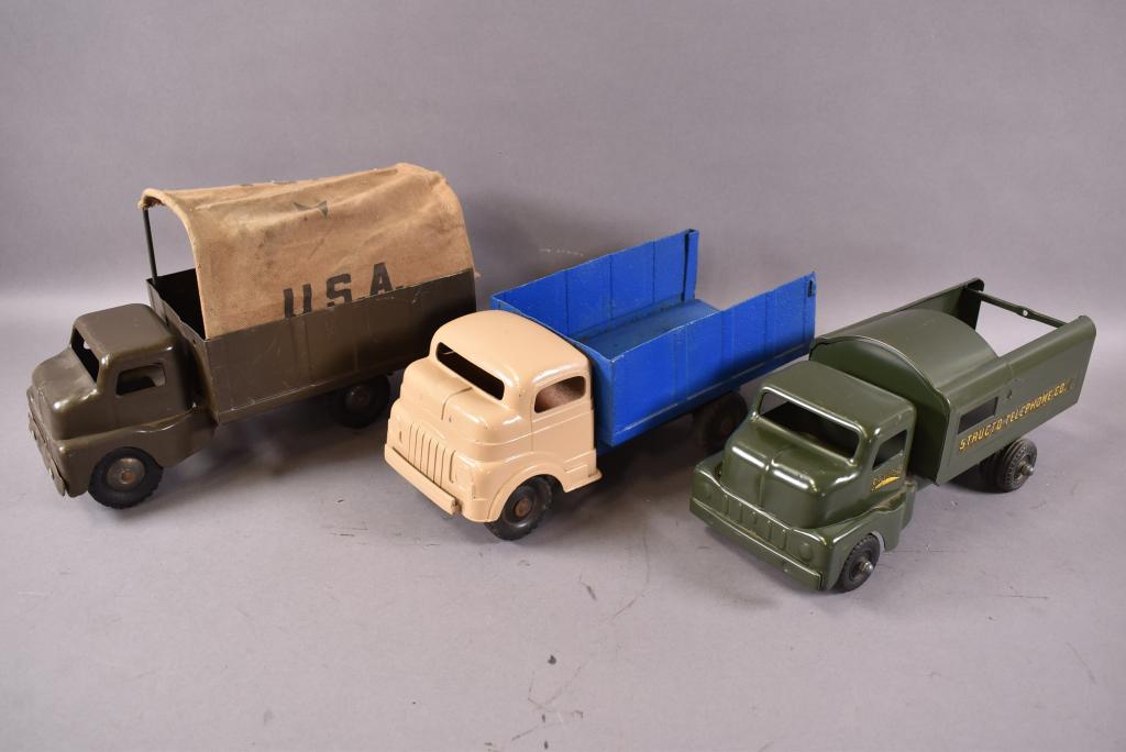 3 STRUCTO TOY TRUCKS: ALL 3 ARE 12 1/2" L, TELEPHONE, ARMY (CANOPY AS IS), & STAKEBED (REPAINTED), SCRATCHES & PAINT LOSS, PLAYED WITH CONDITION