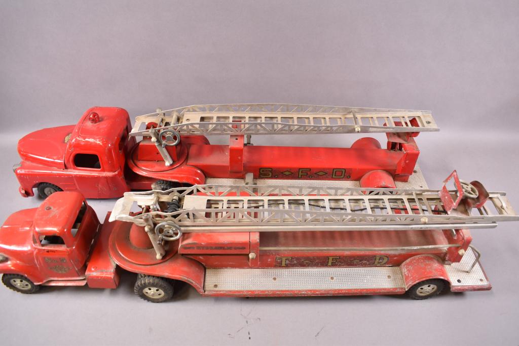 2 HOOK & LADDER TOY FIRETRUCKS: 1 STRUCTO 33" L & 1 TONKA 33" L, LADDERS MISSING FROM BOTH, SIREN MISSING, SCRATCHES AND PAINT LOSS, PLAYED WITH CONDITION.