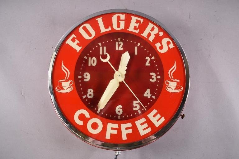 VINTAGE FOLGERS COFFEE NEON CLOCK: 14" DIAM. FOLGERS COFFEE NEON LIGHT UP FACE CLOCK. LIGHTS AND WORKS. ALL CLOCKS SOLD AS IS WE DO NOT GUARANTEE WORKING ORDER.