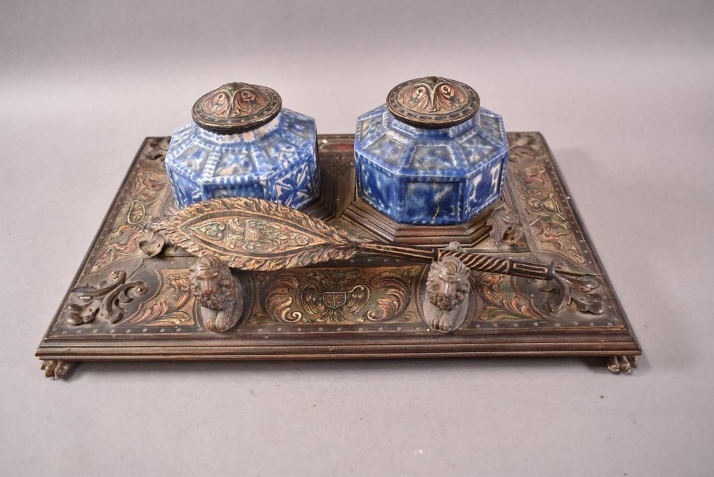 ANTIQUE SPANISH STYLE DOUBLE INKWELL: 2 PORCELAIN VESSELS (1 BROKEN). LION MOTIF PEN HOLDER AND LION PAW FEET. HAND PAINTED SURFACE. GOOD CONDITION. 14" x 9 1/2" x 4 1/2"