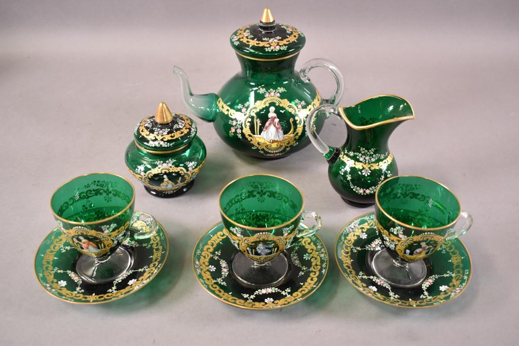 9 PIECE ENAMELED VENETIAN TEA SET: TEA POT, CREAMER AND SUGAR, 3 CUPS AND SAUCERS. ALL HAND PAINTED IN VERY GOOD CONDITION. TEA CUP IS 8" H. CREAMER IS 5" H. SUGAR BOWL IS 5" H. CUPS 3 1/2" H