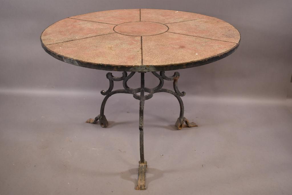 1920s SPANISH STYLE IRON PATIO TABLE: ORIGINAL PAINTED CONCRETE TOP WITH HAND FORGED BASE. ATTRIBUTED TO MISSION INN IN RIVERSIDE CA. SOME RUST AND AGE WEAR THROUGHOUT. OVERALL GOOD CONDITION. 42" DIAM x 30" H