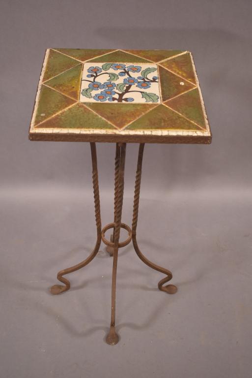 ARTS AND CRAFTS TILE TOP STAND: 13 TILE TOP. IRON BASE. ORIGINAL CONDITION. SOME DAMAGE TO TOP. 13" x 13" x 26"