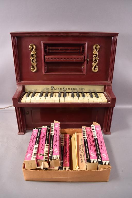 J. CHEIN PIANOLODEON WITH 12 ROLLS: 20" X 10" X 20" ALL ROLLS ARE IN ORIGINAL BOXES. PIANO KEYS WORK BUT UNKNOWN MECHANISM WORKING ORDER