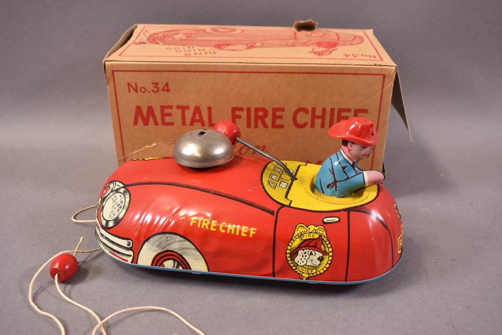 T. COHN METAL FIRE CHIEF PULL TOY: 9" LONG. BOX HAS 1 FLAP MISSING. MINOR SURFACE SCRATCHES