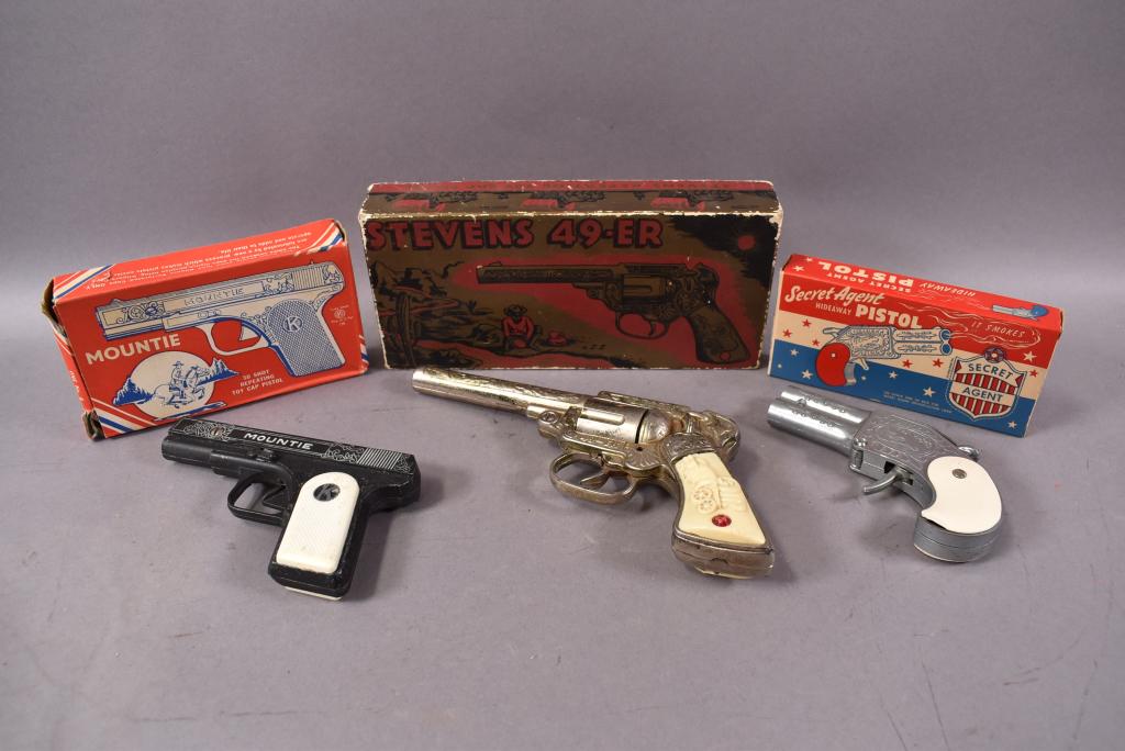 LOT OF 3 CAP GUNS IN ORIGINAL BOXES: STEVENS 49-ER IN PLAYED WITH CONDITION, SOME RUST, 1 PIECE OF OF GRIP IS CHIPPED. KILGORE MOUNTIE IN GOOD CONDITION. HAMILTON SECRET AGENT HIDEAWAY PISTOL IN GOOD CONDITION. BOXES HAVE WEAR