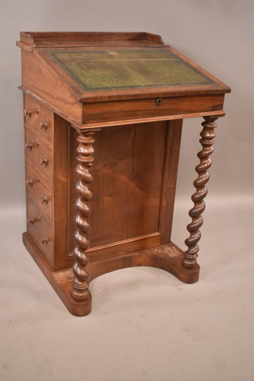 19TH CENTURY ROSEWOOD DAVENPORT DESK: 4 DRAWERS ON RIGHT SIDE W/ INKWELL DRAWER. FAUX DRAWERS ON OPPOSITE SIDE. REPAIR TO HINGE. SPLIT ON TOP OF LID & BACK PANEL. STAINS & WEAR TO FINISH. SOME VENEER MISSING. W.S. PACKER LONDON INK STAMP 