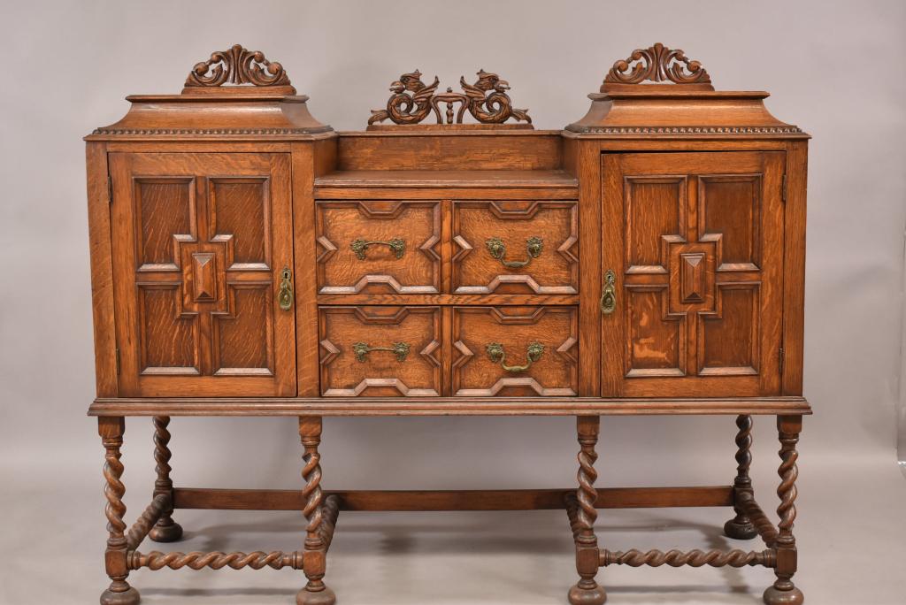 1910'S OAK BARLEY TWIST BUFFET: 2 DRAWER & 2 DOOR LOWER. PANELED FRONT AND SIDES. CARVED BACKSPLASH. FINISH IN GOOD CONDITION. 59" x 20" x 48" THIS ITEM EXCEEDS SIZE LIMITATIONS FOR IN HOUSE SHIPPING.