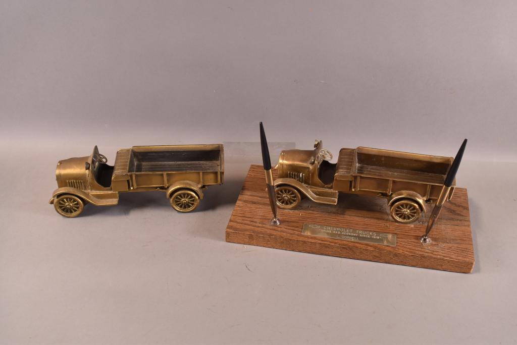 2 CAST METAL CHEVROLET TRUCKS: 1 MADE INTO PEN HOLDER. SURFACE WEAR. 9 1/2" L