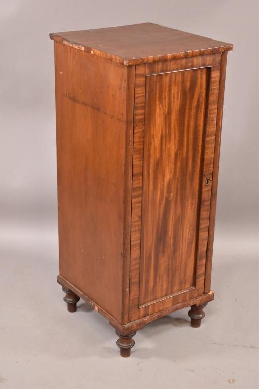 19TH CENTURY NARROW 1 DOOR CABINET: VENEER MISSING AROUND TOP AND BOTTOM EDGE. STAINING TO TOP. FINISH LOSS. 16" x 17" x 41". THIS ITEM EXCEEDS SIZE LIMITATIONS FOR IN HOUSE SHIPPING.