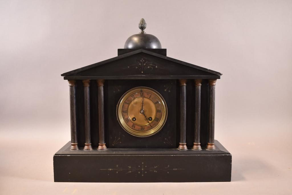 1900'S FRENCH SLATE MANTLE CLOCK: BRASS FACE. CARVED FRONT DESIGN. WITH KEY AND PENDULUM. CHIP TO CORNER. 17" x 6" x 16"
