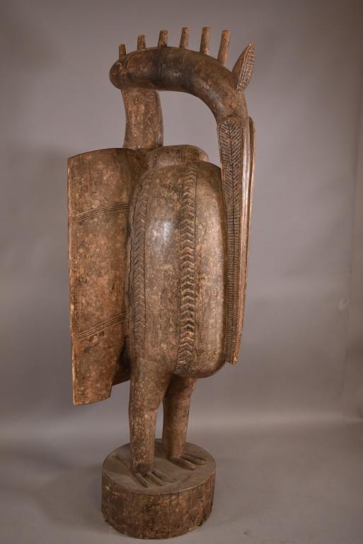 MONUMENTAL SENUFO HORNBILL CARVED WOOD FIGURE 6': AFRICAN SYMBOL OF FERTILITY FOR THE LO & PORO SOCIETIES. CARVED WOOD FIGURE. SCRATCHES. 73" H. THIS ITEM EXCEEDS SIZE LIMITATIONS FOR IN HOUSE SHIPPING.