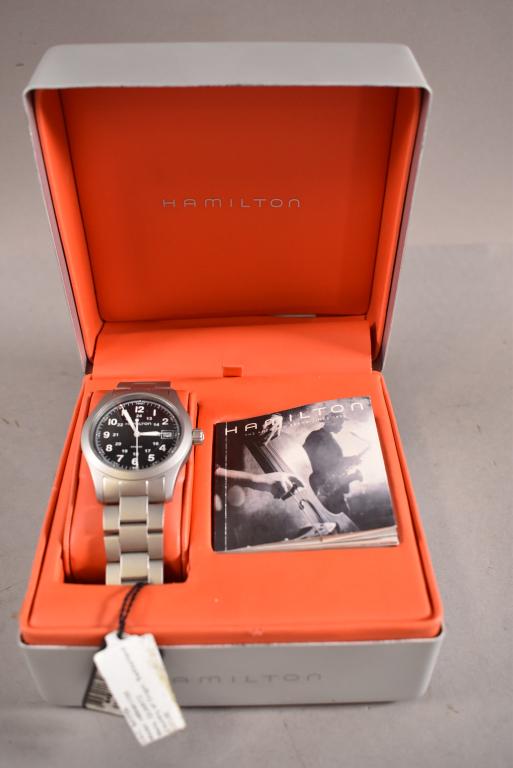 NOS MENS HAMILTON KHAKI WRIST WATCH: SWISS QUARTZ MOVEMENT, BATTERY OPERATED. IN ORIGINAL BOX. ALL WATCHES ARE SOLD AS IS WE DO NOT GUARANTEE WORKING ORDER.