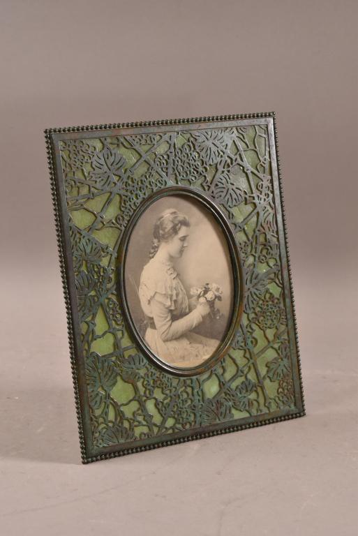 TIFFANY STUDIOS LEADED GLASS FRAME: MARKED TIFFANY STUDIOS NEW YORK. SOME DAMAGE TO GLASS ON BACK. MARKED 946 ON BACK. 8" x 10"