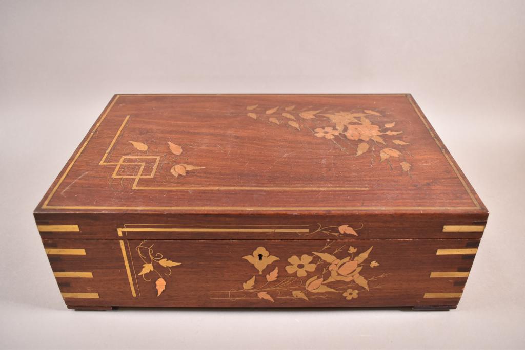 METAL INLAID DRESSER BOX: BRASS FLORAL INLAY ON OUTSIDE AND INTERIOR. WITH INTERIOR TRAY. NO KEY. SOME WEAR TO FINISH ON TOP. 15" x 10" x 5"