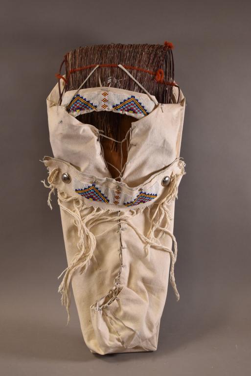 NATIVE AMERICAN CRADLEBOARD: CANVAS WITH BEADWORK. GOOD OVERALL CONDITION. 20" H