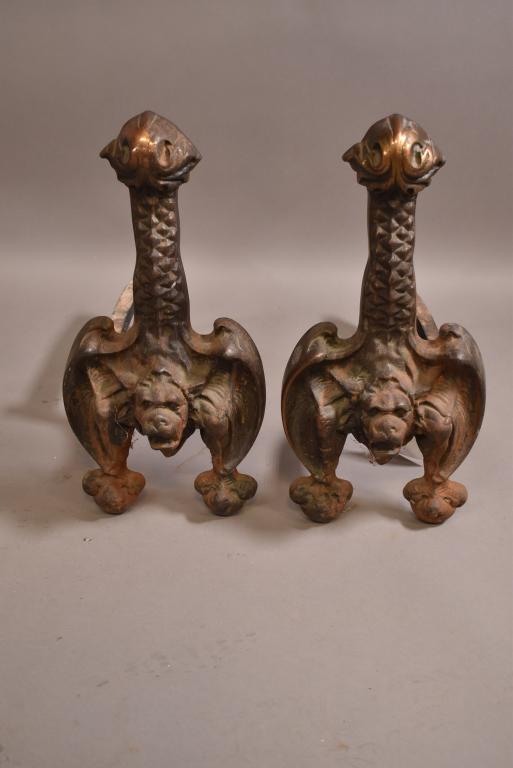 PAIR OF CAST METAL GARGOYLE ANDIRONS: HIGHLY DECORATED FIGURAL GARGOYLES. UNMARKED. WEAR TO PATINA. 19" H. THIS ITEM EXCEEDS SIZE LIMITATIONS FOR IN HOUSE SHIPPING.