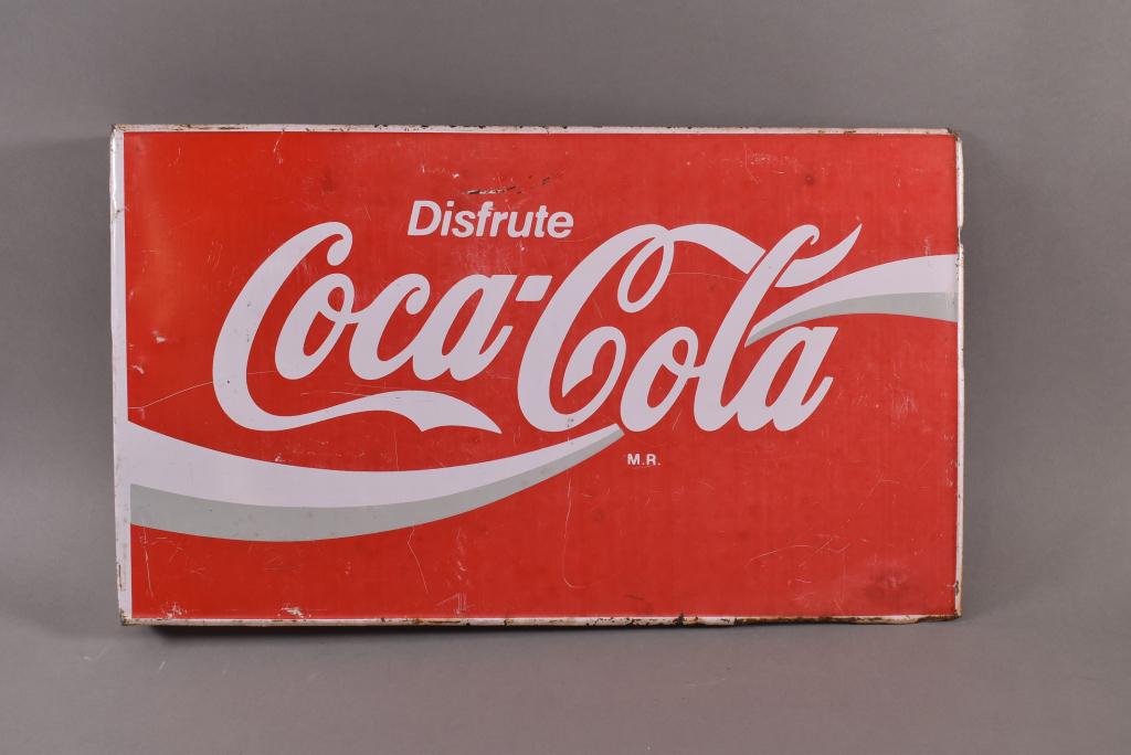 COCA COLA TIN FLANGE: FOREIGN DISFRUTE COCA COLA TIN FLANGE. FADED TO BOTH SIDES WITH SURFACE SCRATCHES. 20" x 12"