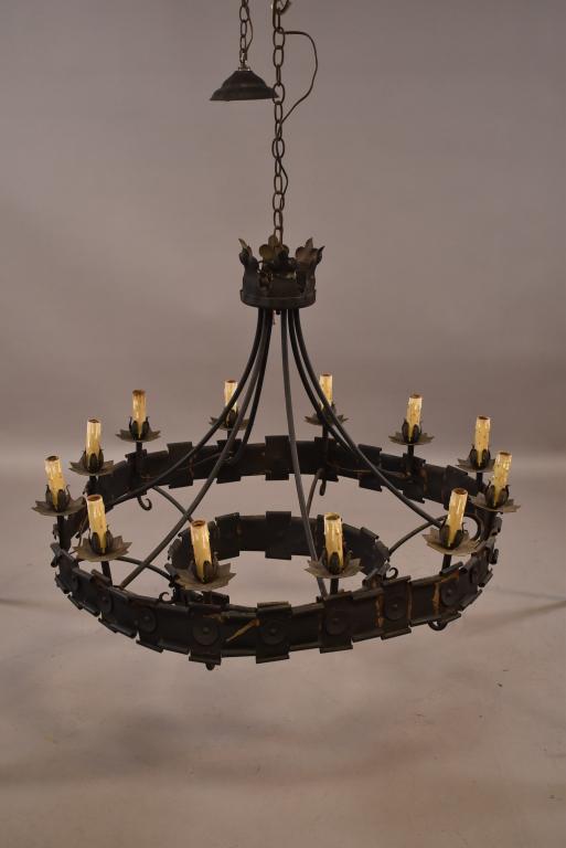 SPANISH STYLE CHANDELLIER: 12 LIGHT METAL CHANDELLIER. DENTED, BENT, AND HAS PAINT LOSS. 33" DIAM x 25" H. THIS ITEM EXCEEDS SIZE LIMITATIONS FOR IN HOUSE SHIPPING.