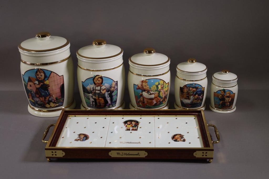 HUMMEL CANISTER SET WITH TRAY: 6 PIECE CANISTER SET. TIMID LITTLE SISTER, BACKYARD HERO, FEEDING TIME, IN TUNE, & LITTLE GOAT HERDER. 1992 DANBURY MINT EDITION. WITH UMBRELLA BOY AND GIRL TRAY. GOOD CONDITION.