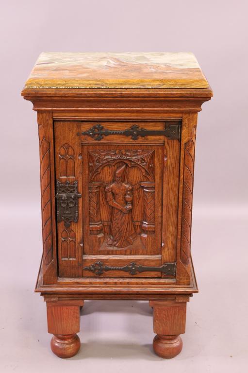 1900'S GOTHIC OAK ONYX TOP NIGHTSTAND.: LEGS HAVE BEEN ADDED. SINGLE DOOR WITH CARVED FIGURE. 18" X 15" X 33". THIS ITEM EXCEEDS SIZE LIMITATIONS FOR IN HOUSE SHIPPING.