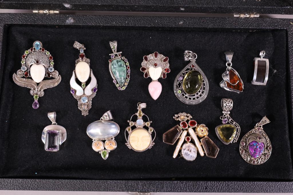 13 PIECES OF STERLING BROACHES: STONES, CRYSTALS, CATS EYE. ALL MARKED STERLING. SHOWCASE NOT INCLUDED.