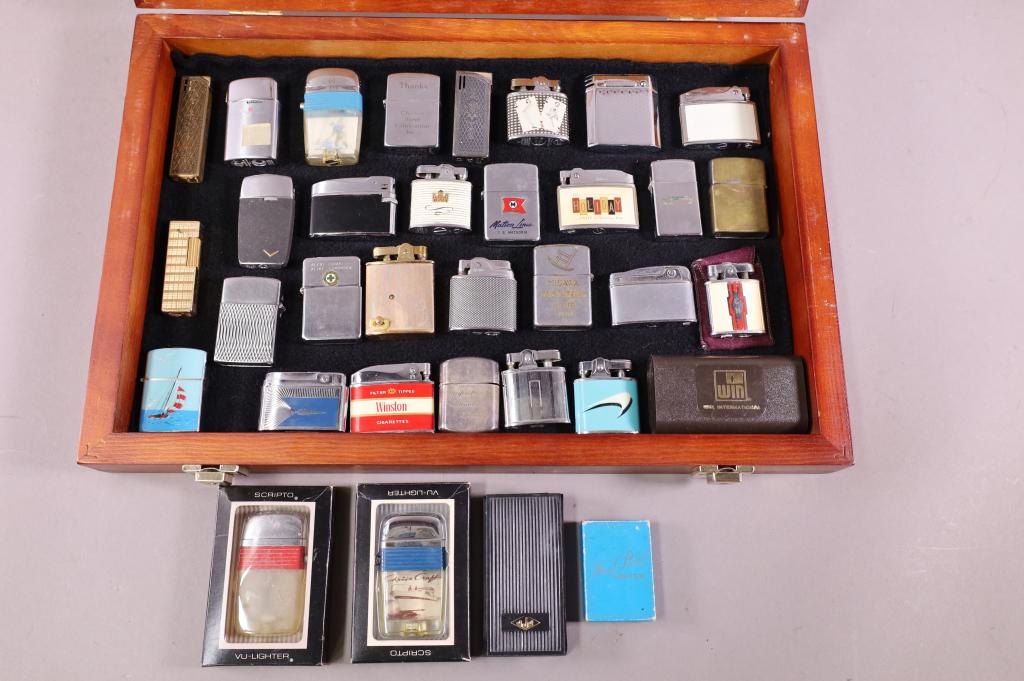 COLLECTION OF LIGHTERS: 34 VINTAGE LIGHTERS INCL: OMEGA, PENGUIN, RONSON AND MORE. SOME HAVE SOME SURFACE KNICKS AND SCRATCHES. SOME IN ORIGINAL BOXES. SHOWCASE NOT INCLUDED