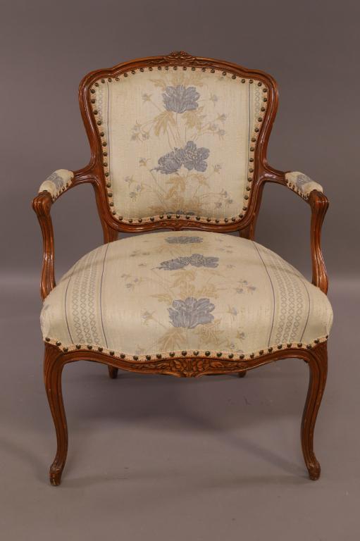 FRENCH STYLE ARMCHAIR: BRASS TACKED, FLORAL UPHOLSTERY. MINOR WEAR TO LEGS. 25" W x 27" D x 36" H. THIS ITEM EXCEEDS SIZE LIMITATIONS FOR IN HOUSE SHIPPING.