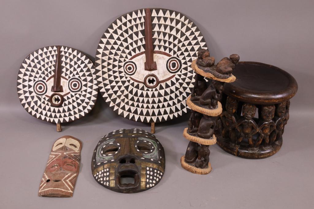6 PIECES OF WOOD CARVED AFRICAN ART: 4 CARVED FACE MASKS, STOOL, & TOTEM. SOME ARE HAND PAINTED. HAND CARVED. SOME AGE SPLITS. PAINT LOSS. TOTEM HAS SOME LOSS. LARGEST MASK IS 25" DIAM / STOOL IS 17" DIAM x 15" H. THIS ITEM EXCEEDS SIZE 