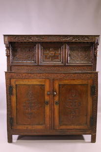 17TH CENTURY CARVED CUPBOARD: HIGHLY CARVED OAK CUPBOARD. DATED 1685. 4 DOORS. IRON HINGES. MISSING ONE PIECE IN UPPER LEFT. AGE SPLITS. 56" W x 21" D x 66" H. THIS ITEM EXCEEDS SIZE LIMITATIONS FOR IN HOUSE SHIPPING.