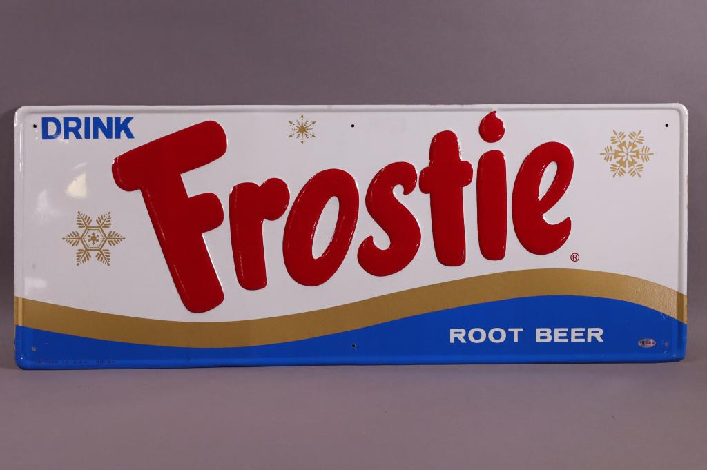 DRINK FROSTIE ROOT BEER SST SIGN: DRINK FROSTIE ROOT BEER SELF FRAMED EMBOSSED SST SIGN. TAC AUTHENTICATED 016184. MINOR SURFACE SCRATCHES, GOOD COLOR. 28" x 11"