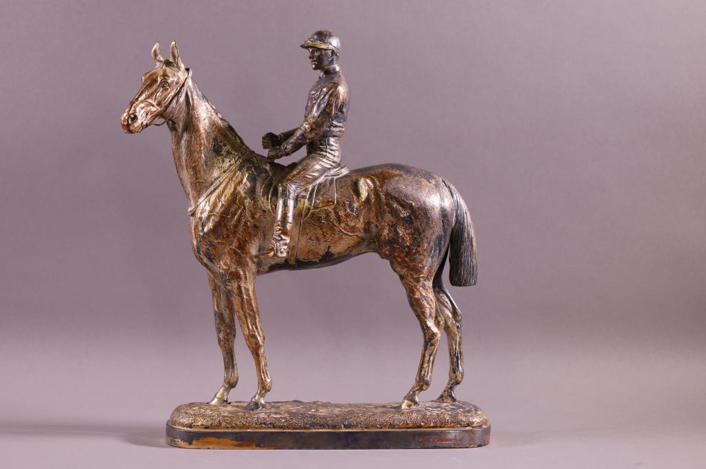 19TH CENTURY JOCKEY ON HORSE SILVERED STATUE: PRESENTATION PIECE MARKED WILLIS GOOD 1875, ROSEBERY FROM HRH THE PRINCE OF WALES CHRISTMAS 1893. SOME SILVERING GONE. 12" W x 12" H.