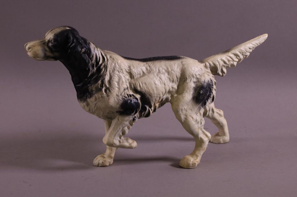 CAST IRON DOG DOORSTOP: CONTEMPORARY CAST IRON DOG DOORSTOP. PAINTED FINISH, SOME PAINT LOSS. 15" L x 8" H.