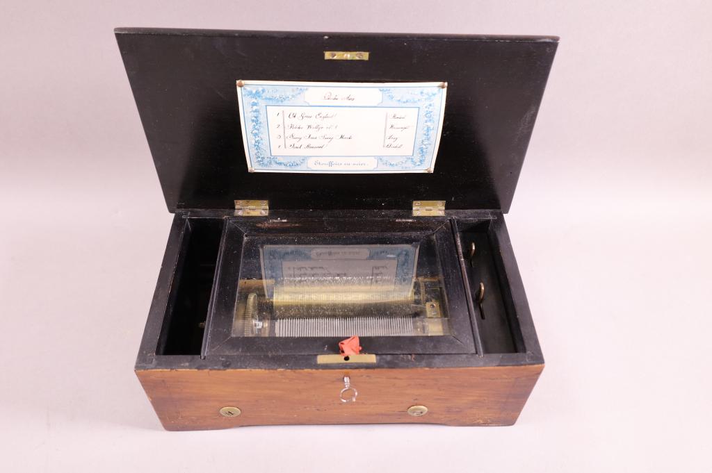 SMALL SWISS MUSIC BOX: INLAID SWISS SINGLE COMB CYLINDER MUSIC BOX. 4 SONGS. WITH KEY. WORKING. SCRATCHES AND WEAR TO FINISH. 12 1/2" W x 7" D x 4 1/2" H.