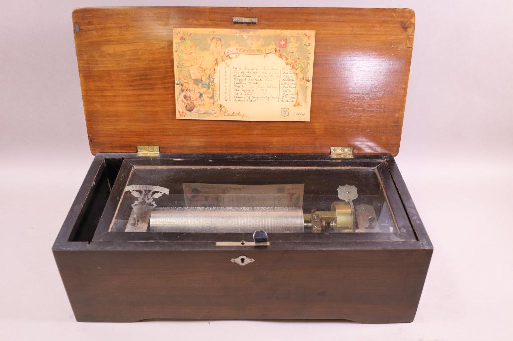 SWISS CYLINDER MUSIC BOX: SWISS SINGLE COMB, CYLINDER MUSIC PLAYER. 9" L CYLINDER. NO KEY, CASE IS AS IS. WORKING. 20" W x 9" D x 6" H. THIS ITEM EXCEEDS SIZE LIMITATIONS FOR IN HOUSE SHIPPING.