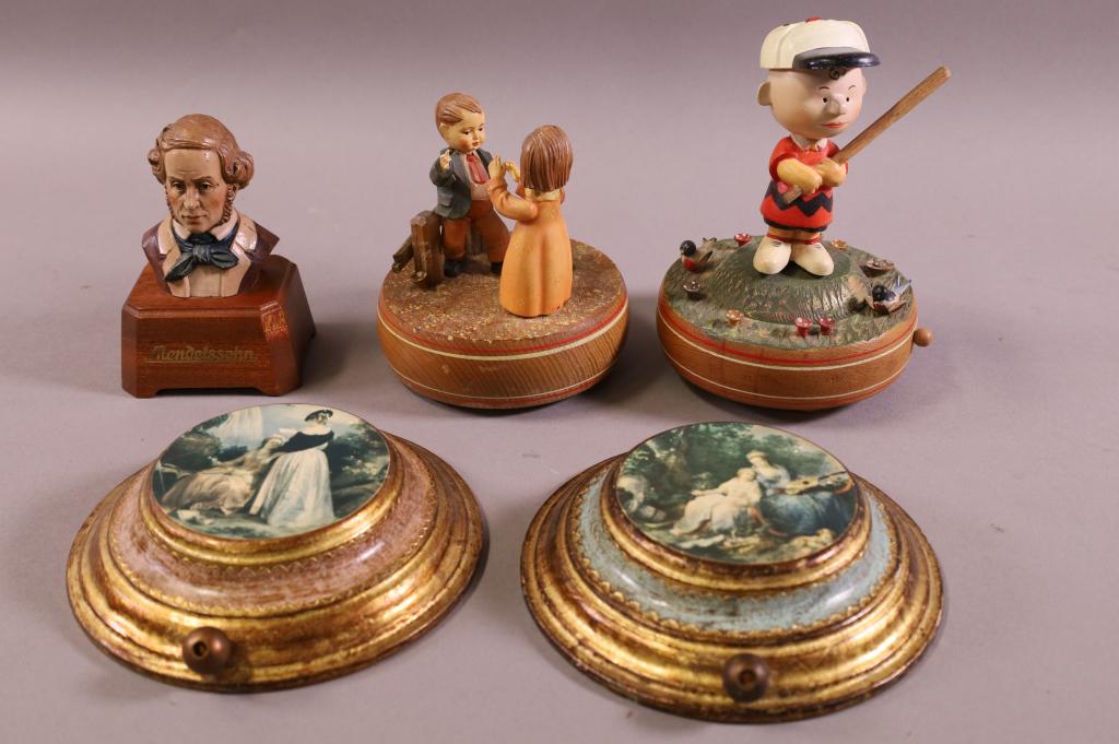 5 MISC MUSIC BOXES: 2 REUGE WALL PLAQUE STYLE MUSICAL BOXES, WORKING, 6" DIAM. REUGE CHARLIE BROWN MUSICAL FIGURE, WORKING, 6" H. REUGE DOUBLE MUSICAL FIGURE, WORKING, 6" H. REUGE MENDELLLSHON WORKING, 5" H.
