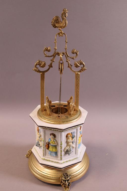 WISHING WELL MUSIC BOX: METAL AND PORCELAIN . MUSIC WORKS BUT BUCKET DOES NOT LIFT. 17" H.