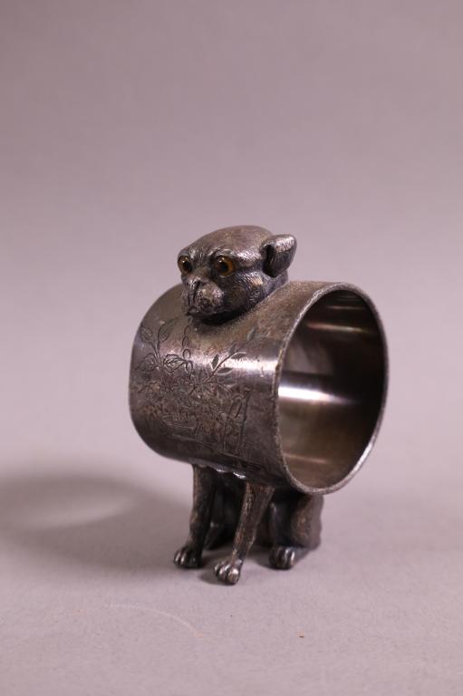 VICTORIAN DOG NAPKIN RING: DOG FORM WITH GLASS EYES, UNMARKED. 3" H.