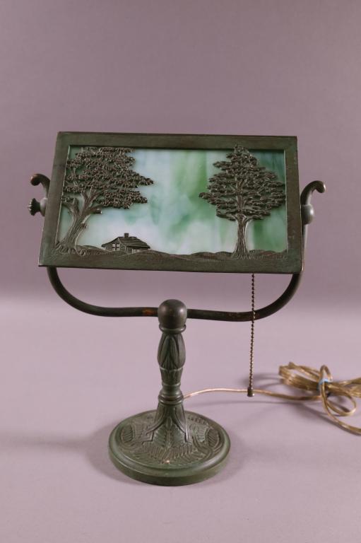 1920'S SLAG GLASS DESK LAMP: SCENIC SLAG GLASS DESK LAMP. ATTRIB TO BRADLEY AND HUBBARD. GOOD CONDITION. SHADE 9" x 8" / 13" H.