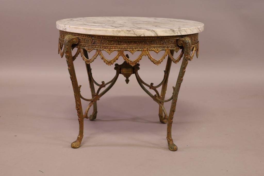 FRENCH STYLE MARBLE TOP BRASS LAMP TABLE: GILT BRASS BASE WITH MARBLE TOP. GOOD CONDITION. 22" DIAM x 18" H. THIS ITEM EXCEEDS SIZE LIMITATIONS FOR IN HOUSE SHIPPING.