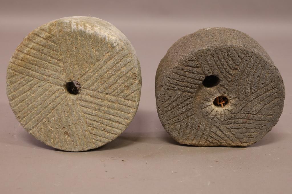 2 MILL STONES: 2 CARVED STONE MILL STONES. GRIST MILL STONE. 12" DIAM x 4 3/4" W / 11" DIAM x 4 1/2" W. THIS ITEM EXCEEDS SIZE LIMITATIONS FOR IN HOUSE SHIPPING.