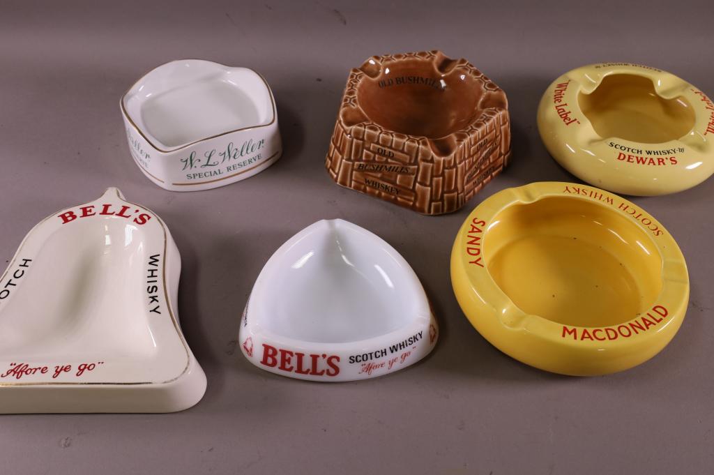 6 WHISKY/WHISKEY ADVERTISING ASHTRAYS: PORCELAIN AND GLASS. BUSHMILLS, BELLS, DEWARS, & MORE.