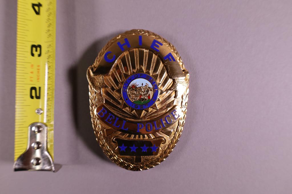 OBSOLETE BELL POLICE CHIEF BADGE: MARKED APRIL ON REVERSE .