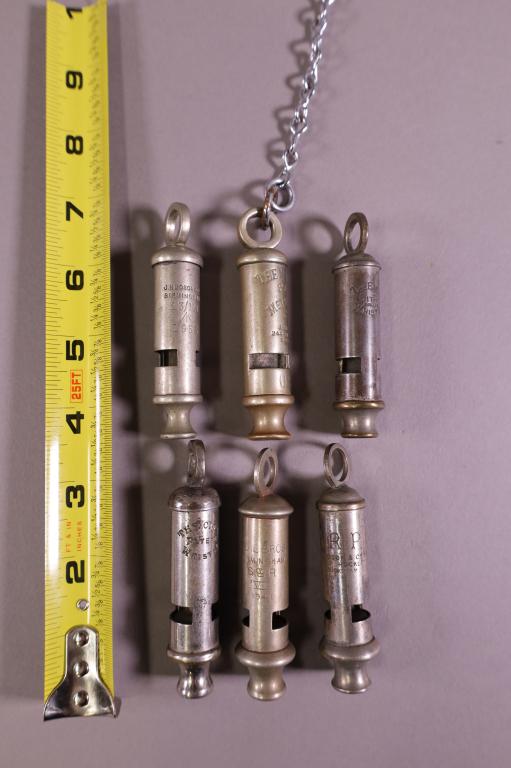 5 POLICE WHISTLES: MARKED THE METROPOLITAN, THE CITY WHISTLE, THE EMCA CITY WHISTLE, ADIE, 2 A.R.P HUDSON WHISTLE.