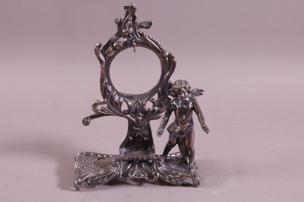 SILVERPLATED CHERUB POCKETWATCH HOLDER: UNMARKED. GOOD CONDITION. 8" H.