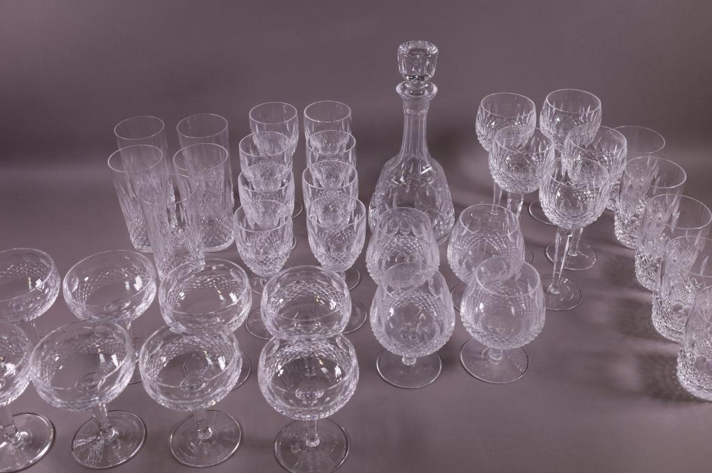 COLLECTION OF 31 PCS. WATERFORD CRYSTAL: 31 PIECES, DECANTER, FIVE 4 1/2" WATER GLASSES, FIVE 7 1/2" WINE GLASSES, FOUR 5 1/2" SNIFTERS, EIGHT 6 3/4" WINE GLASSES, FIVE 6" WATER GLASSES, SEVEN 5 1/2" WINE GLASSES. GOOD CONDITION.